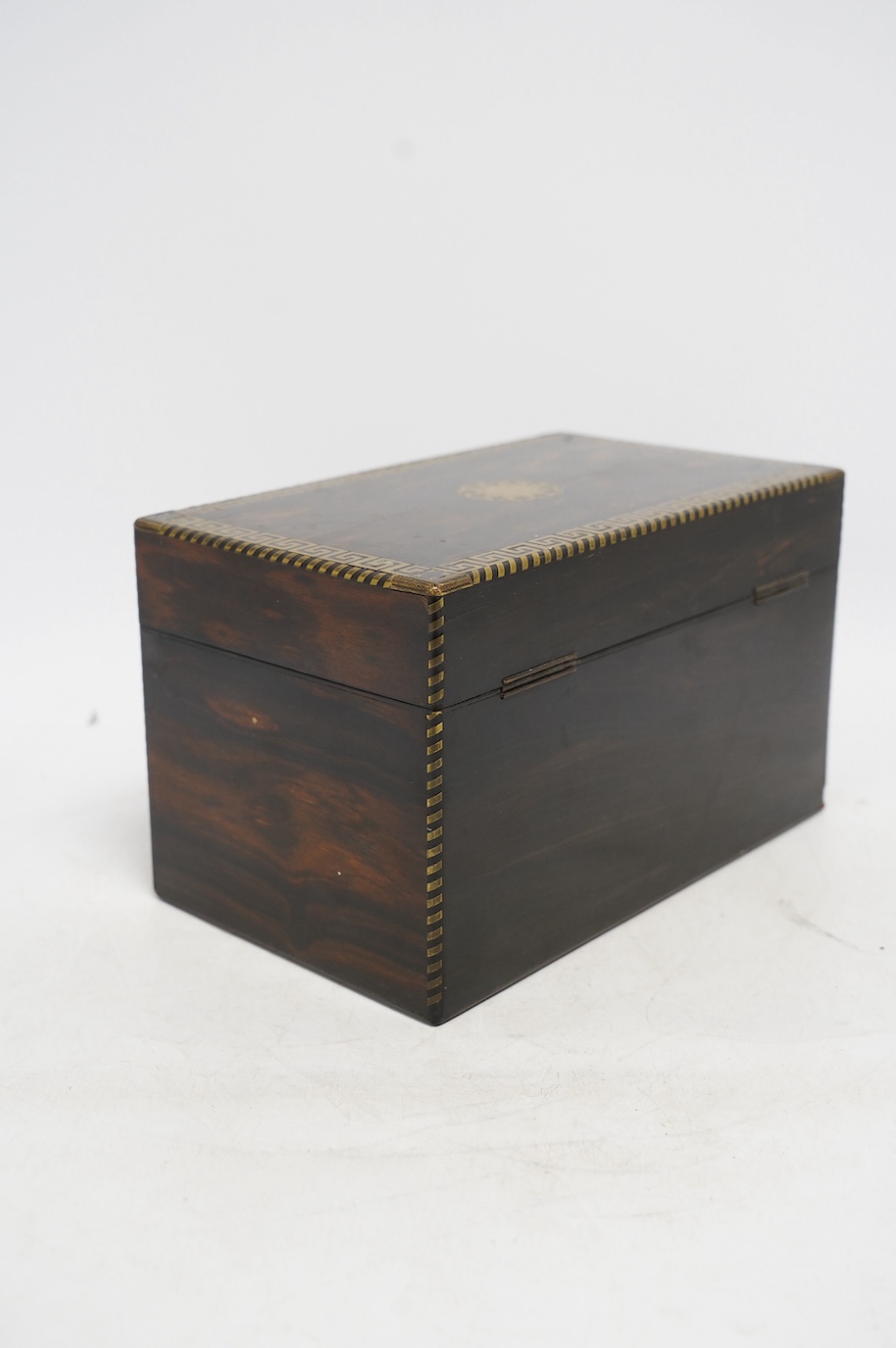 An early 19th century brass inlaid coromandel tea caddy with birch lining, 25cm wide. Condition - fair